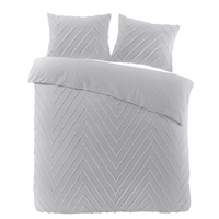 Een bed met twee kussens en een grijs dekbed, uitnodigend en comfortabel ingericht voor een goede nachtrust.