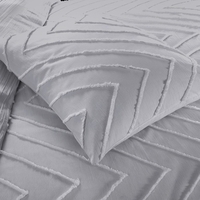 Nauwkeurige weergave van een bed met kussens en een grijs chevronpatroon, perfect voor een rustgevende slaapkamer.