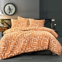 Een oranje en wit bed met een witte klok op het nachtkastje, perfect voor een ontspannen slaapkameromgeving.